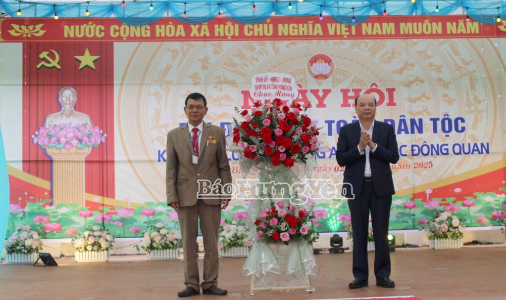 Đồng chí Đặng Thanh Giang, Ủy viên Ban Thường vụ Tỉnh ủy, Phó Chủ tịch HĐND tỉnh tặng hoa chúc mừng thôn Đông An, xã Bắc Đông Quan nhân Ngày hội Đại đoàn kết toàn dân tộc.