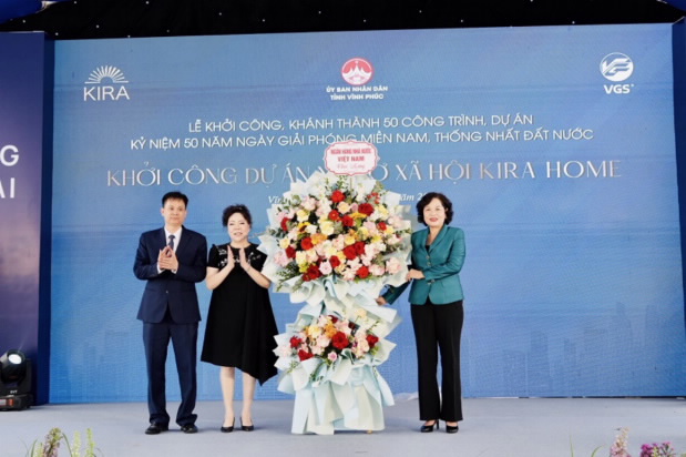 A group of people standing in front of a large flower display AI-generated content may be incorrect.